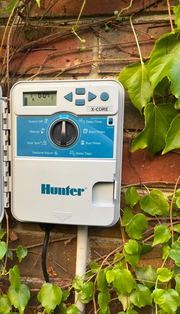 Hunter irrigation controller on brick wall