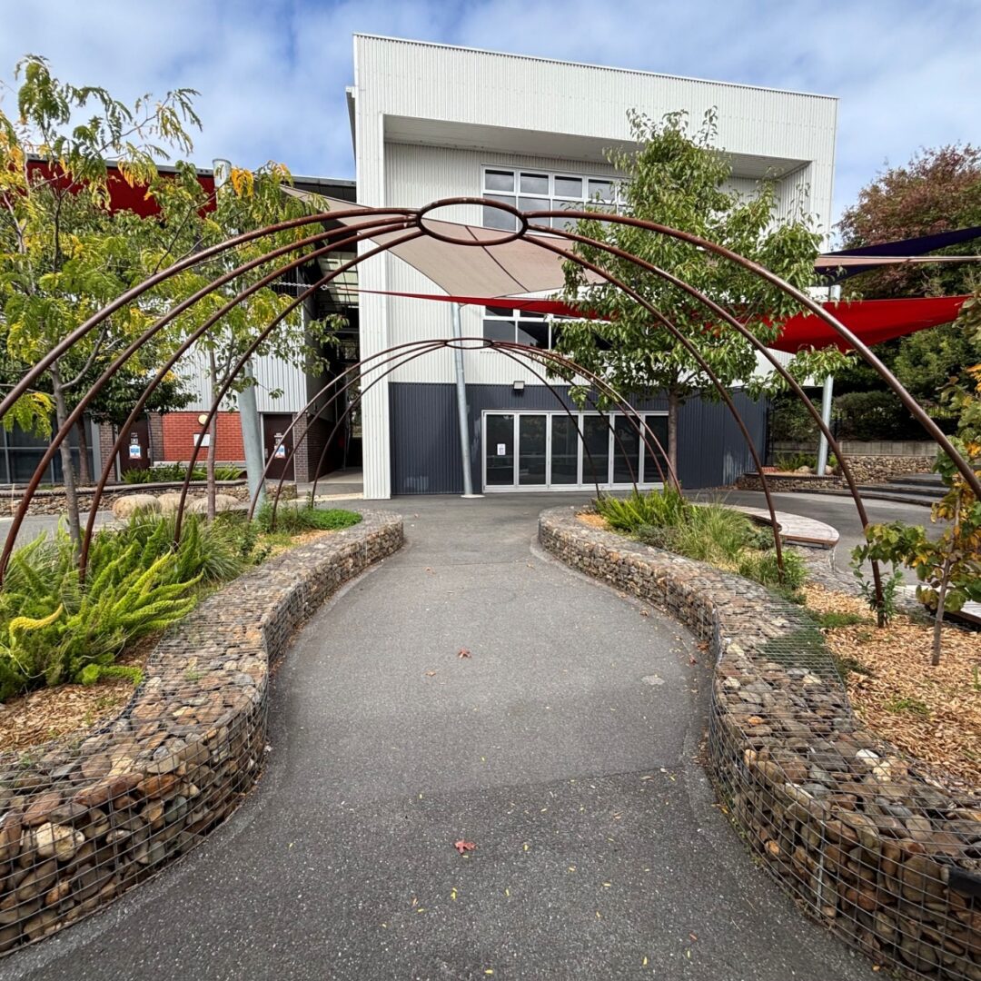 Pathway under metal arches to building entrance