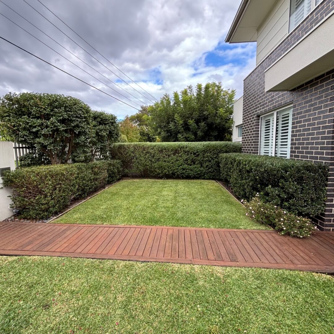Modern brick house front yard with hedges