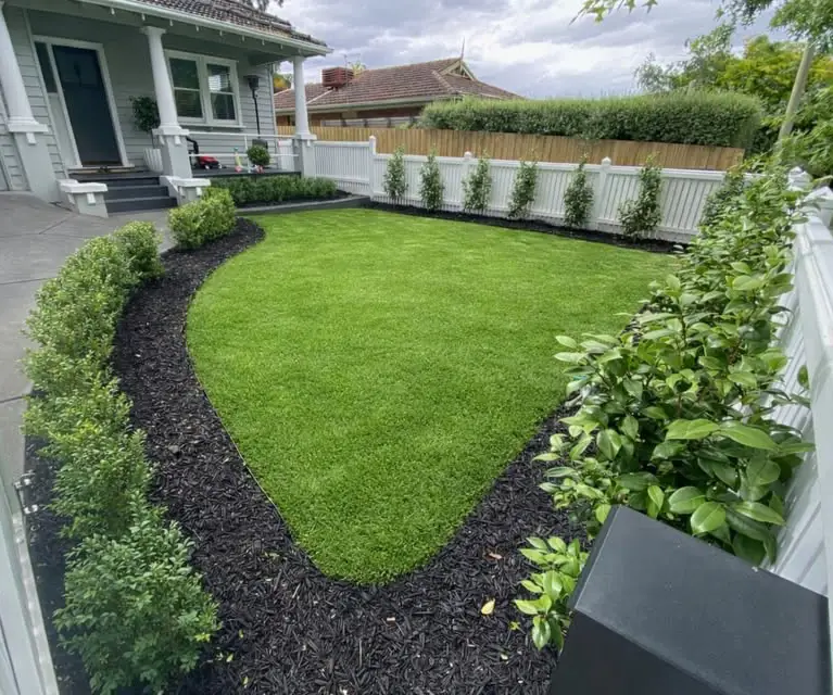 Front yard landscaping with lawn, mulch, hedges